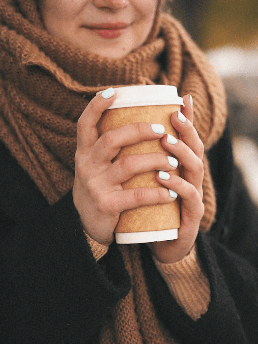 A person is holding a coffee cup