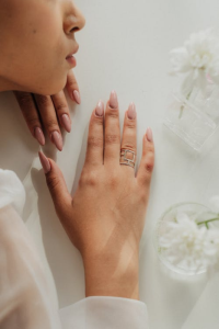A person with nude press-on nails